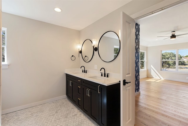 bathroom with vanity, hardwood / wood-style flooring, and ceiling fan