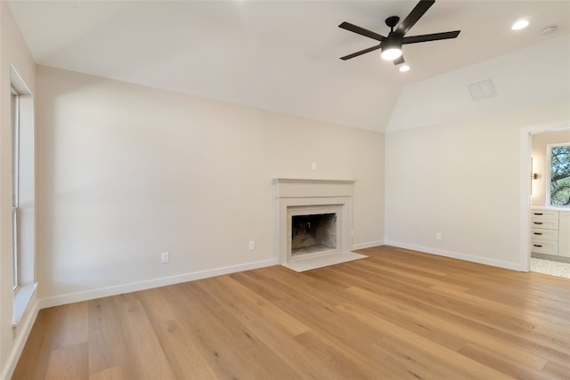 unfurnished living room featuring ceiling fan, lofted ceiling, and light wood-type flooring