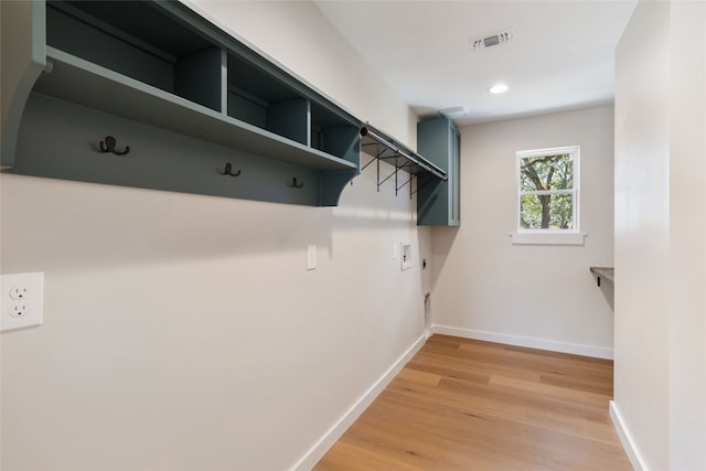 interior space featuring hookup for an electric dryer, wood-type flooring, and washer hookup