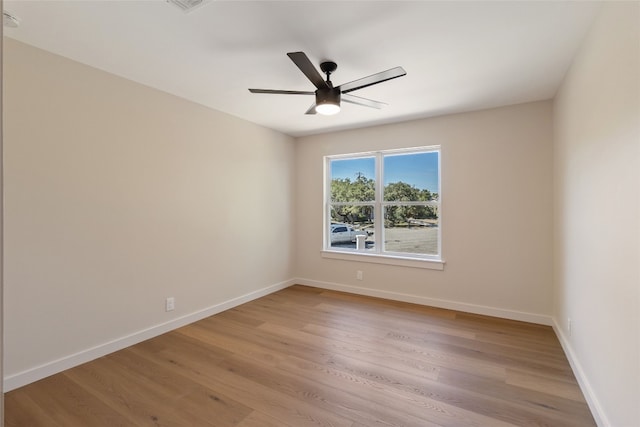 empty room featuring light wood-type flooring and ceiling fan