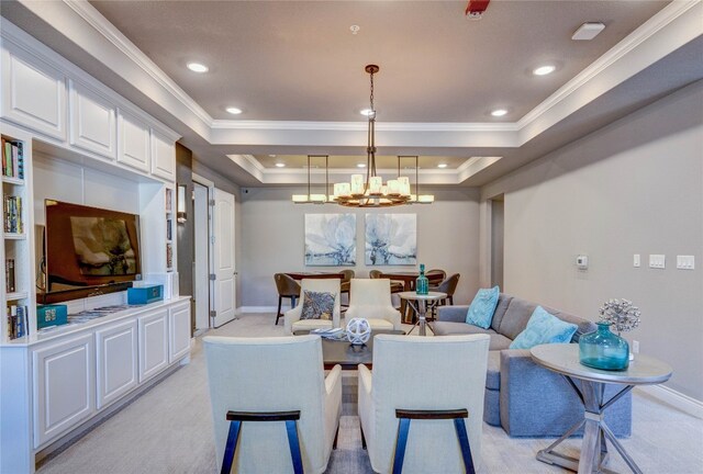 dining room featuring a chandelier, light colored carpet, and a tray ceiling