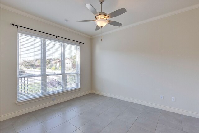 tiled empty room featuring crown molding and ceiling fan