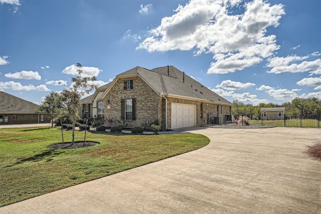 view of front of home with a garage and a front lawn