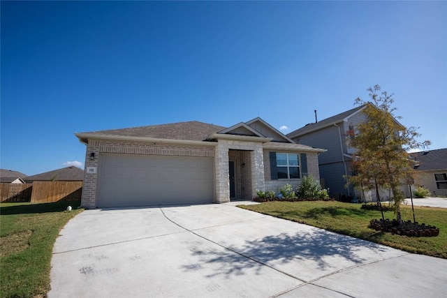 ranch-style house featuring a garage and a front lawn