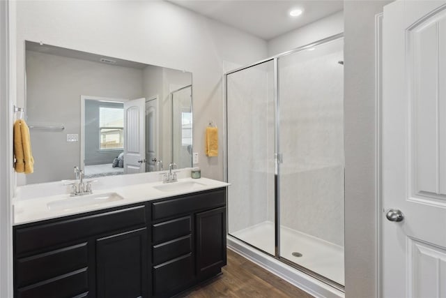 bathroom with vanity, wood-type flooring, and a shower with door