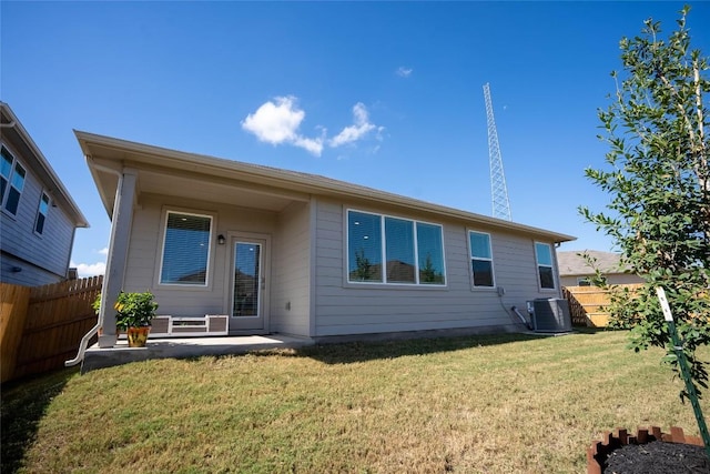 back of house with a lawn, a patio, and central air condition unit