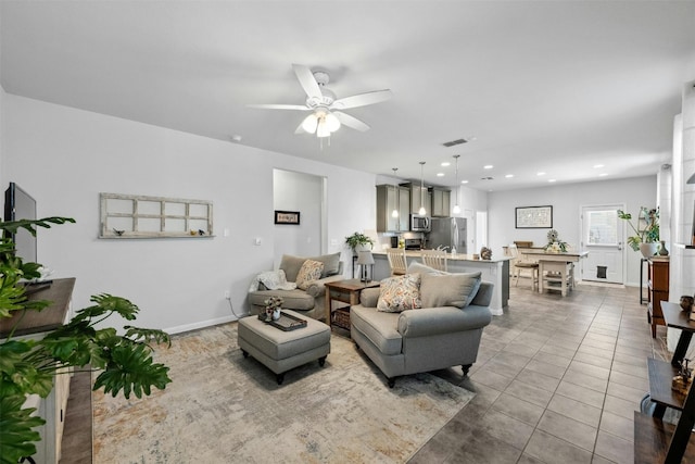 living room with tile patterned floors and ceiling fan