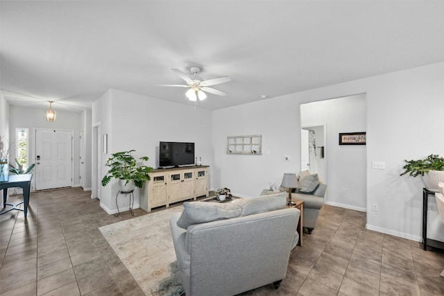 tiled living room with ceiling fan