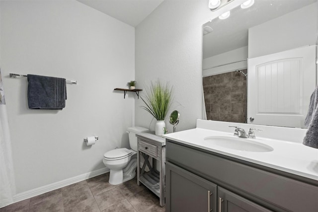 bathroom featuring tile patterned flooring, vanity, and toilet