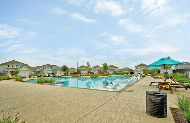 view of swimming pool with central AC unit and a patio area