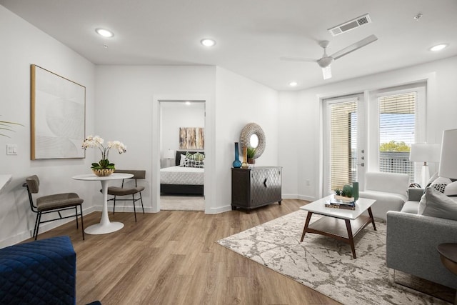 living room featuring ceiling fan and hardwood / wood-style flooring