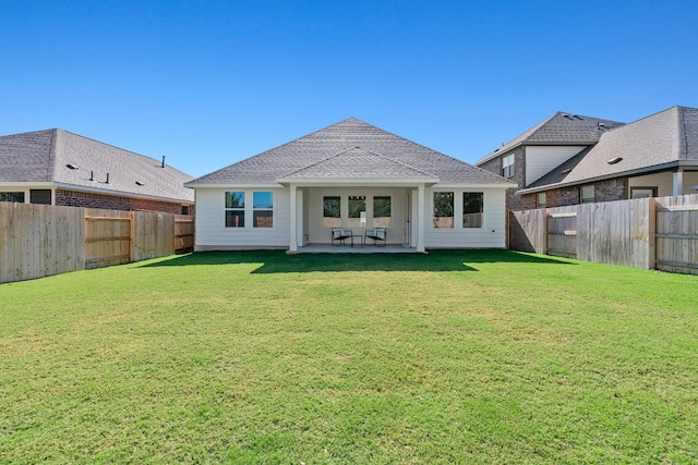 back of property with a patio and a lawn