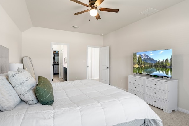 bedroom featuring light colored carpet, ensuite bath, ceiling fan, and lofted ceiling