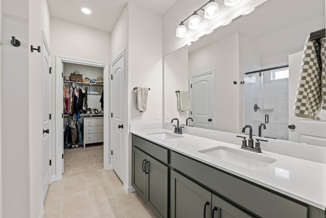 bathroom with tile patterned floors, vanity, and an enclosed shower