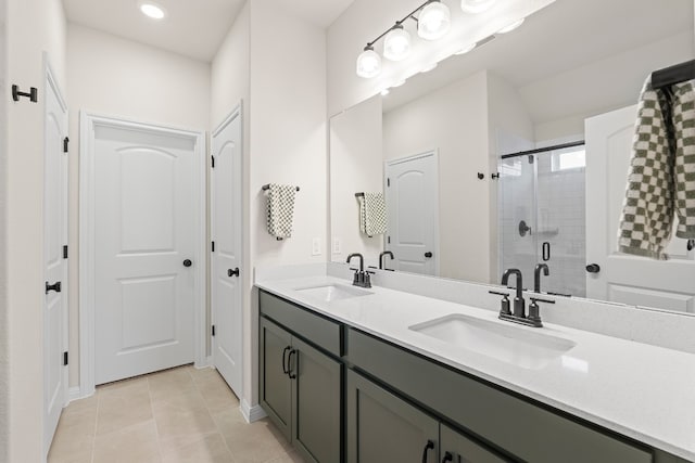 bathroom featuring tile patterned flooring, vanity, and an enclosed shower