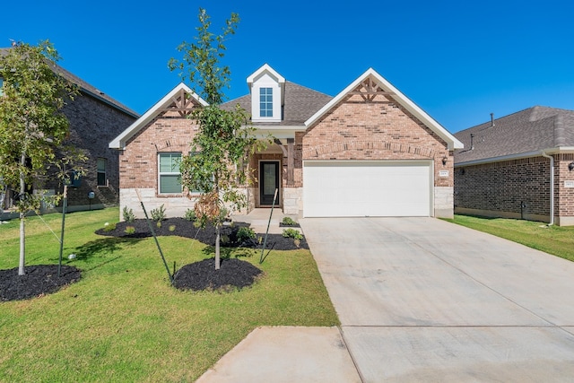 view of front of property featuring a garage and a front yard