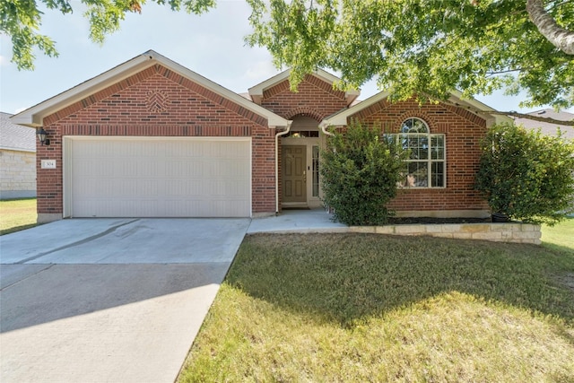 view of front of property featuring a front yard and a garage