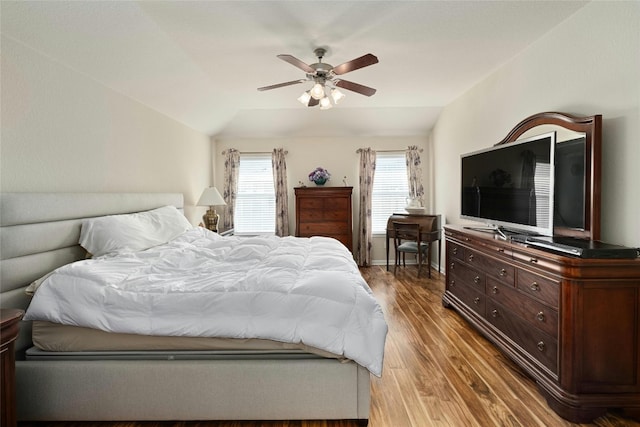 bedroom featuring lofted ceiling, hardwood / wood-style flooring, and ceiling fan