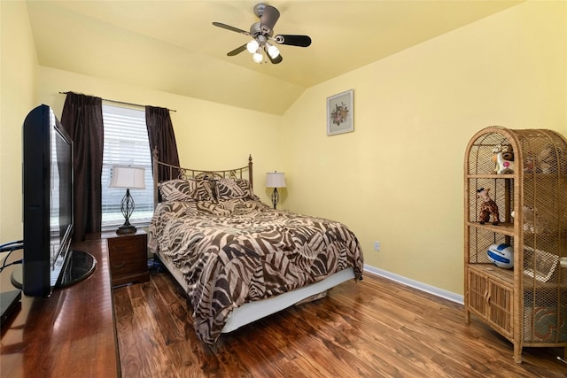 bedroom with dark hardwood / wood-style flooring, ceiling fan, and vaulted ceiling