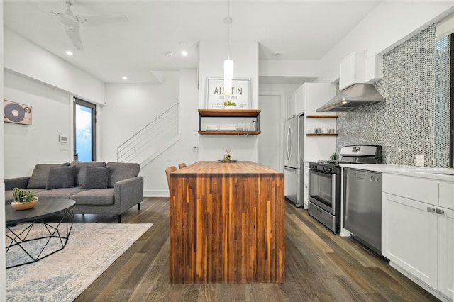 kitchen with open shelves, stainless steel appliances, wooden counters, white cabinetry, and decorative backsplash