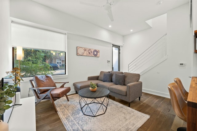 living room with ceiling fan and dark hardwood / wood-style flooring