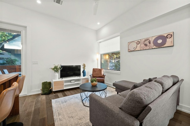 living room with dark wood-style flooring, recessed lighting, and baseboards