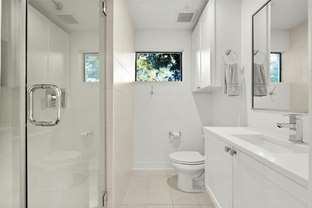 bathroom with toilet, healthy amount of natural light, a stall shower, and tile patterned flooring