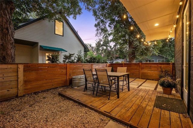 wooden deck featuring a fenced backyard and outdoor dining area