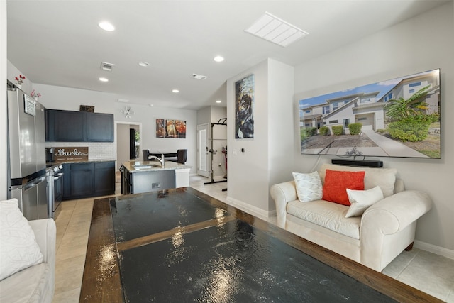 tiled living room featuring sink