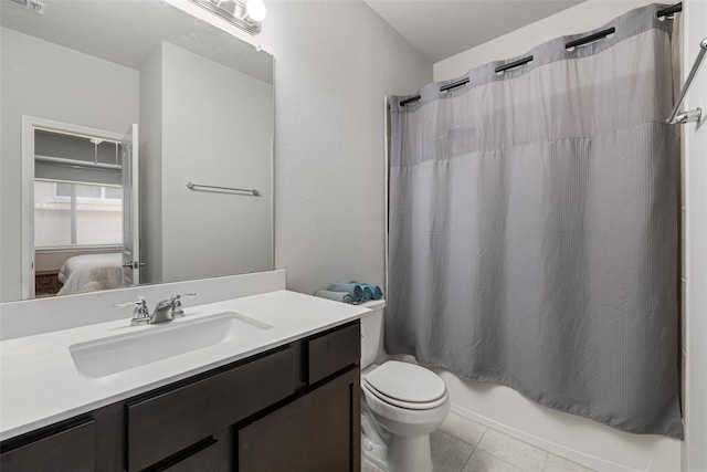 full bathroom featuring vanity, shower / tub combo with curtain, toilet, and tile patterned floors