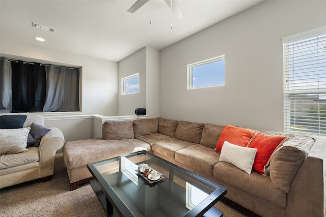 carpeted living room featuring ceiling fan