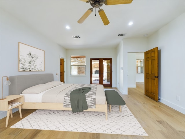 bedroom featuring french doors, light hardwood / wood-style floors, and ceiling fan