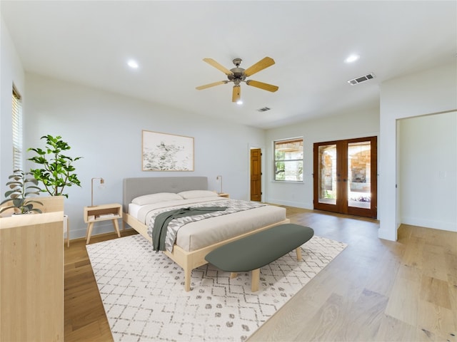 bedroom with light hardwood / wood-style flooring, french doors, access to exterior, and ceiling fan