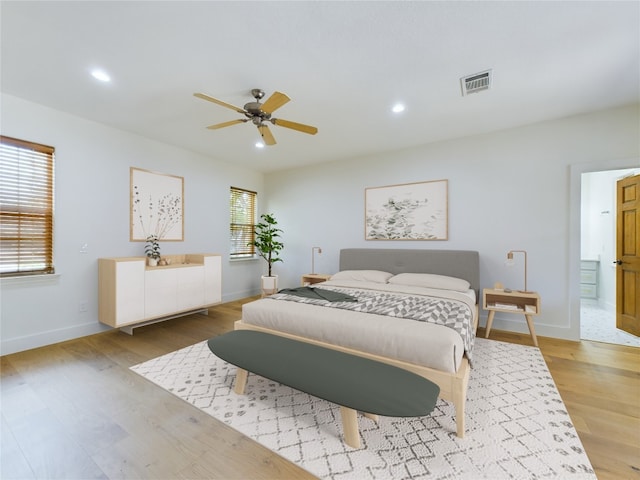 bedroom featuring light hardwood / wood-style floors, multiple windows, and ceiling fan