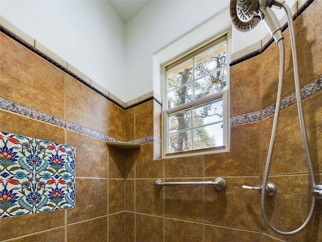 bathroom with a tile shower