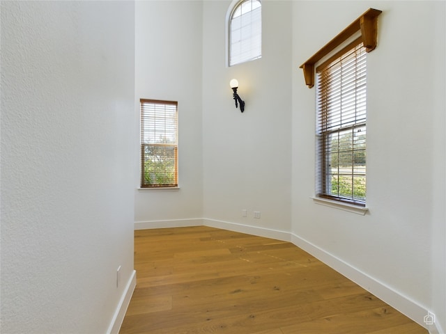 empty room with light hardwood / wood-style flooring