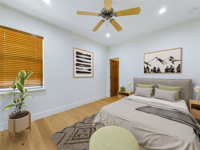 bedroom with light hardwood / wood-style floors and ceiling fan