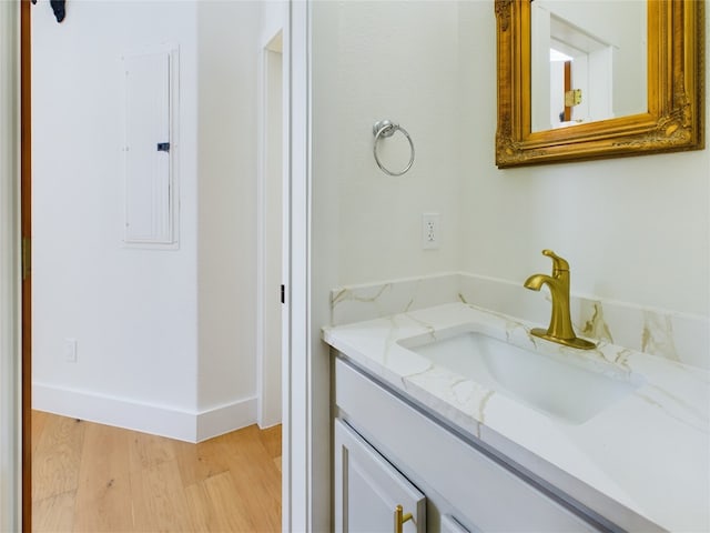 bathroom featuring vanity, hardwood / wood-style floors, and electric panel