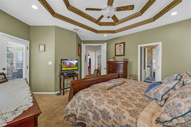 bedroom featuring ceiling fan, a raised ceiling, ensuite bathroom, light carpet, and ornamental molding