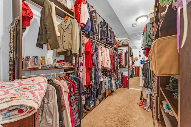 walk in closet featuring carpet floors