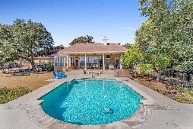 view of swimming pool featuring ceiling fan, a patio area, a yard, and a hot tub