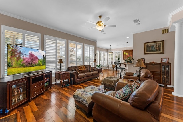 living room featuring ornate columns, crown molding, dark hardwood / wood-style flooring, and ceiling fan