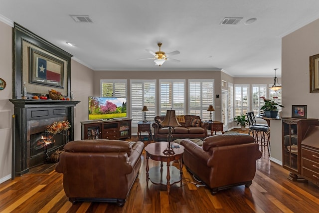 living room with ornamental molding, dark hardwood / wood-style floors, and a healthy amount of sunlight