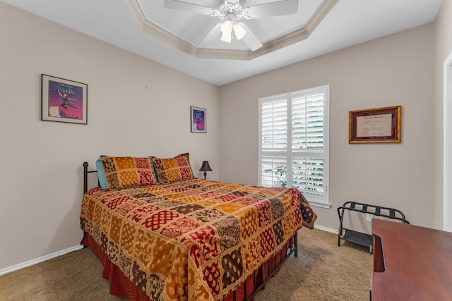 bedroom with carpet floors, a tray ceiling, ceiling fan, and crown molding