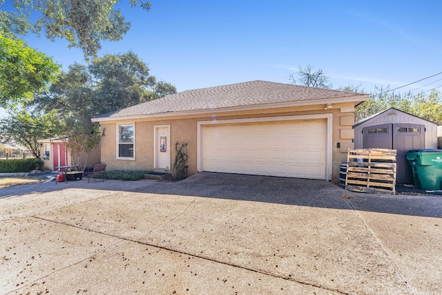 ranch-style home with a storage unit and a garage