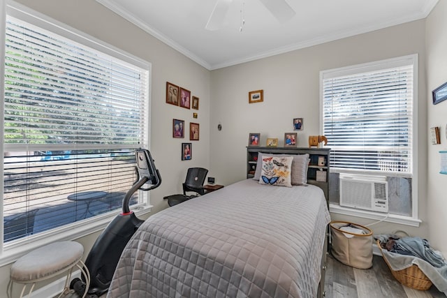 bedroom with multiple windows, ceiling fan, crown molding, and wood-type flooring