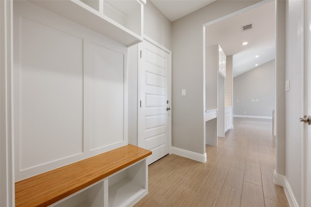 mudroom with light hardwood / wood-style floors