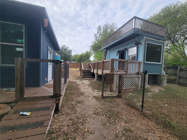 view of side of home with a wooden deck