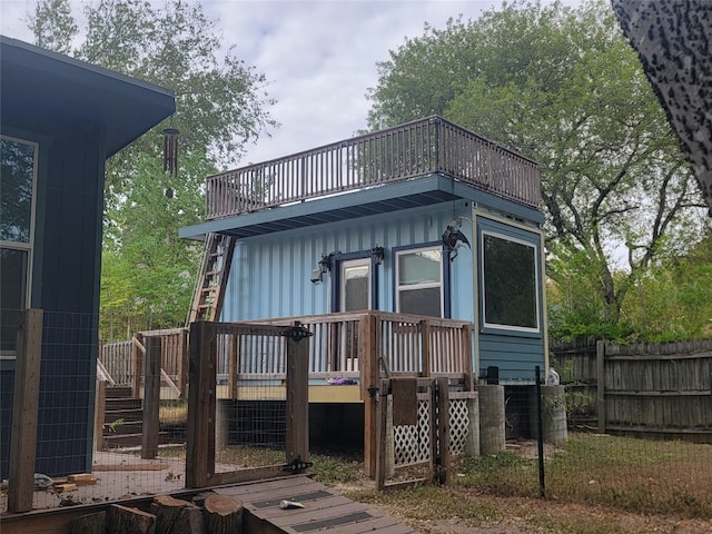 back of property featuring a wooden deck