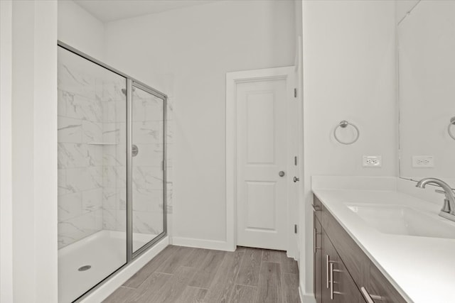 bathroom with vanity and a shower with shower door